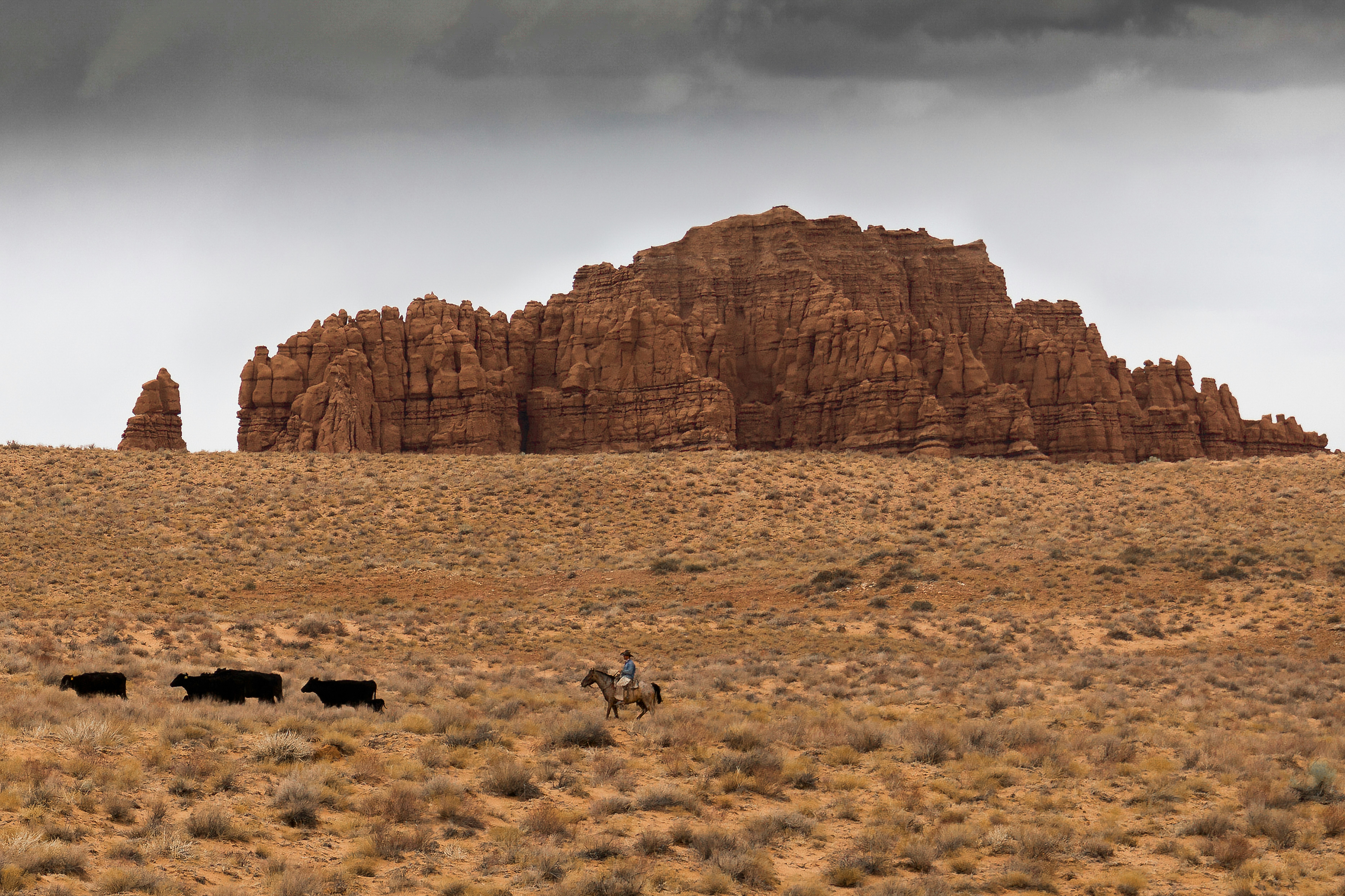 people on brown field near brown rock formation during daytime